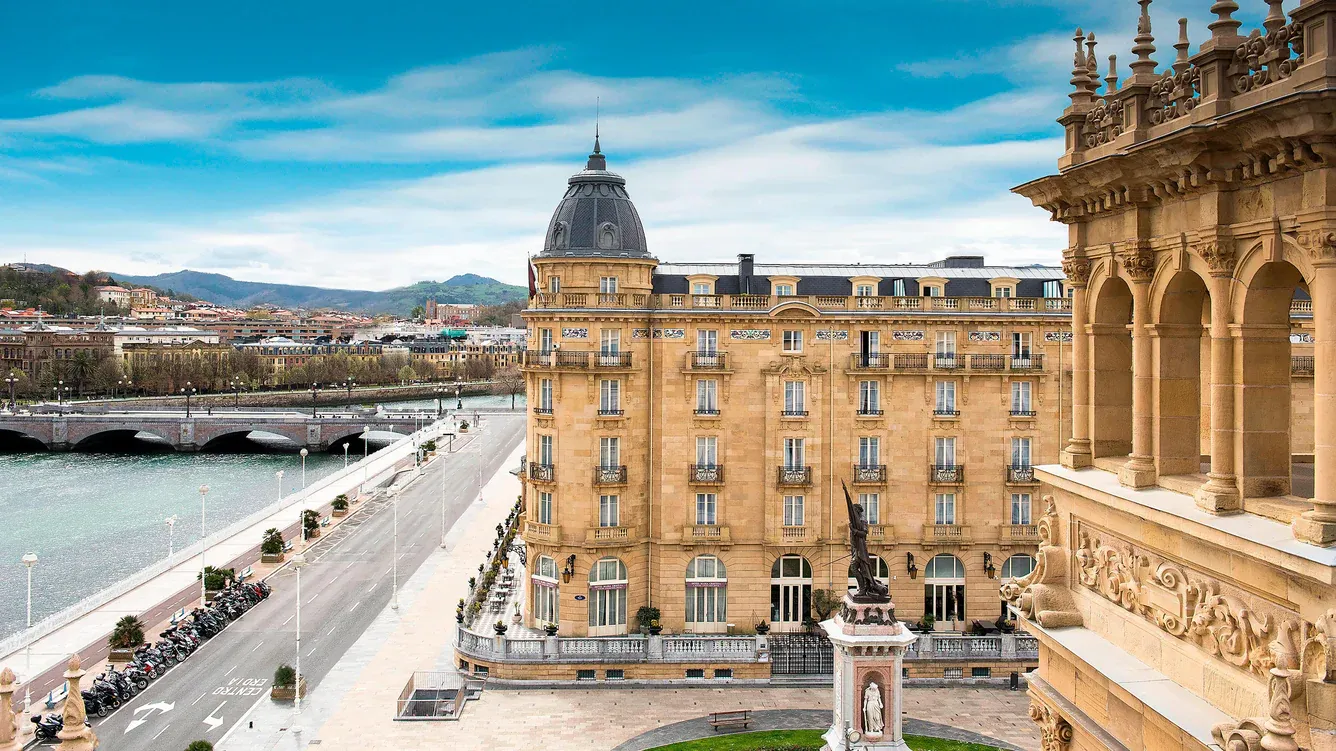 The sandstone façade of Hotel María Cristina, with its domed corner turret, beside the Urumea
